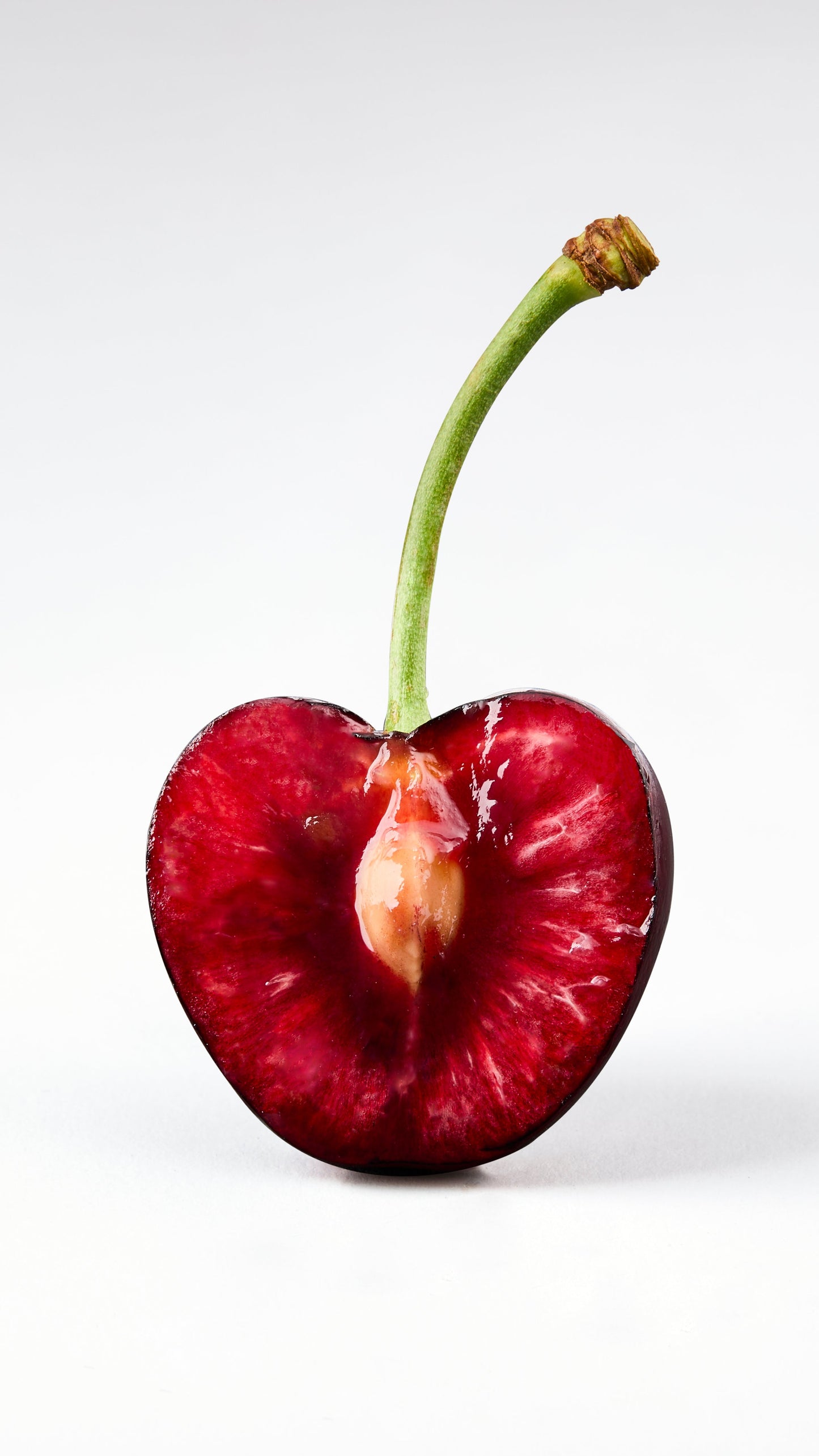 Half of a cherry on a white background